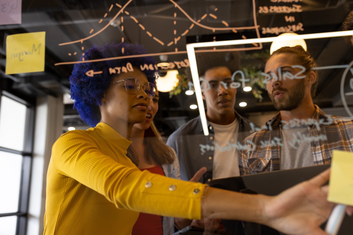 Early-career employees collaborating with senior colleagues in a discussion