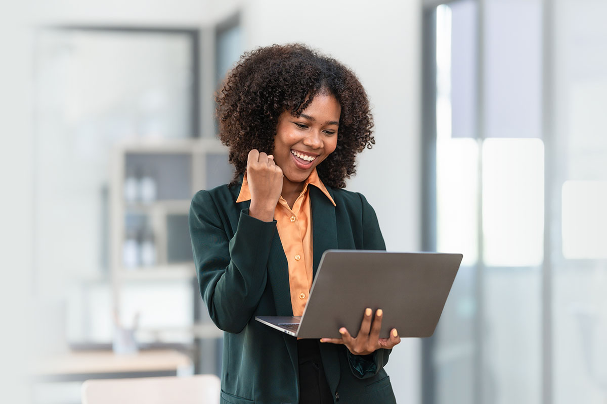 HR professional reviewing payroll documents and financial reports at a modern office desk